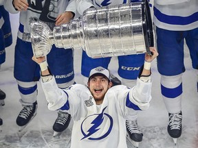Tampa Bay Lightning centre Anthony Cirelli (71) hoists the Stanley Cup after defeating the Dallas Stars at Rogers Place.