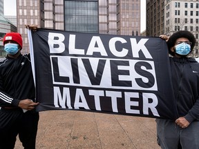 People protest against the death of Casey Goodson Jr., a 23-year-old Black man who was killed by police last week as he entered his home, outside of the State House in Columbus, Ohio, U.S., December 12, 2020.