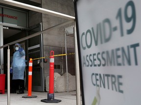 A nurse guides people being tested for COVID-19 outside a hospital in Toronto.