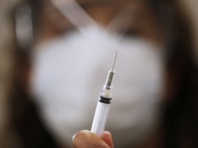 LoriAnn Laramee prepares dilutant for the COVID-19 vaccine in the COVID-19 vaccination clinic at the Health Sciences Centre in Winnipeg, Wednesday, December 16, 2020.