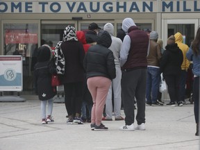 Shoppers line up to get into Vaughan Mills mall before full lockdown in York Region on Sunday, December 13, 2020.