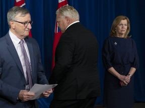 Dr. David Williams, Ontario's Chief Medical Officer, left to right, Premier Doug Ford and Health Minister Christine Elliott attend a news conference at the Ontario legislature in Toronto on Wednesday, November 25, 2020.