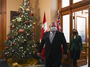 Ontario Premier Doug Ford and Ontario Health Minister Christine Elliott leave the premiers office before holding a press conference at Queen's Park during the COVID-19 pandemic in Toronto on Monday, December 21, 2020.