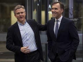 Former Ontario Finance Minister Rod Phillips jokes around with Former Federal Minister of Finance Bill Morneau on Monday December 16, 2019 in the Foyer of West block in Ottawa.