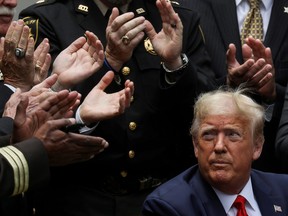 U.S. President Donald Trump listens to applause after signing an executive order on police reform during a ceremony in the Rose Garden at the White House in Washington, June 16, 2020.