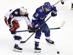 Brayden Point of the Tampa Bay Lightning and Pierre-Luc Dubois of the Columbus Blue Jackets battle for the puck during the 2020 NHL Stanley Cup Playoffs at Scotiabank Arena on August 13, 2020 in Toronto.