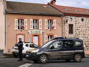A French Gendarme stands in front of the city hall in Saint-Just  on December 23, 2020, after three gendarmes were killed and a fourth wounded by a gunman they confronted in response to a domestic violence call.