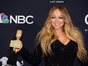 Mariah Carey poses in the press room with her Icon Award during the 2019 Billboard Music Awards at the MGM Grand Garden Arena in Las Vegas, May 1, 2019.