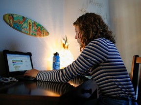 High school freshman, Maddie Weiser, studies from her home after her school was closed due to the pandemic outside Denver, Colorado, November 19, 2020.