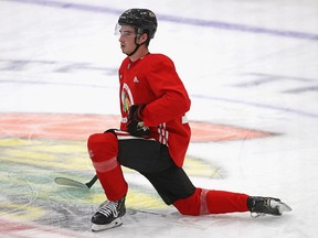Kirby Dach of the Chicago Blackhawks stretches after a summer training camp July 14, 2020 in Chicago.