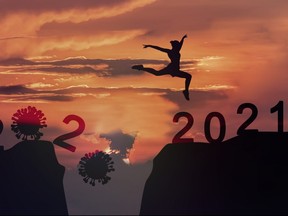Young woman Jumping across the gap of the mountain from COVID-19 to 2021 New Year.