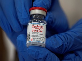 Michelle Chester, DNP, director, employee health services, Northwell shows the Moderna coronavirus disease (COVID-19) vaccine at Northwell Health's Long Island Jewish Valley Stream hospital in New York, U.S., December 21, 2020.