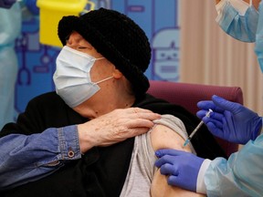 Nursing home resident Milagros Garcia, 79, receives an injection with a dose of the Pfizer-BioNTech COVID-19 vaccine, in Lleida, Spain, Sunday, Dec. 27, 2020.