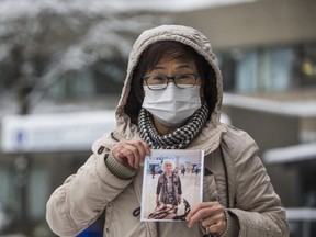 Jenny Diep holds up a photo of her mother Muoi Ha, 93 -- a resident at Tendercare Nursing Home in Scarborough who died of COVID-19 on Christmas Eve -- on Saturday, Dec. 26, 2020.