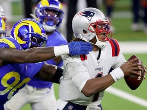 The Patriots confirmed that Cam Newton, right, will remain the starting quarterback for now, despite poor play. Getty images