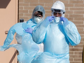 Healthcare workers walk in personal protective equipment (PPE) outside the Wyckoff Heights Medical Center during the outbreak of the coronavirus disease (COVID-19) in the Brooklyn borough of New York City, April 6, 2020.