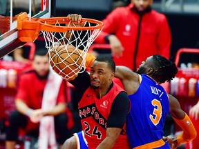 Norman Powell of the Toronto Raptors dunks the ball against Nerlens Noel of the New York Knicks at Amalie Arena on December 31, 2020 in Tampa.