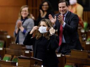 Finance Minister Chrystia Freeland removes her protective mask before speaking in the House of Commons after unveiling her first fiscal update, the Fall Economic Statement 2020, in Ottawa, November 30, 2020.