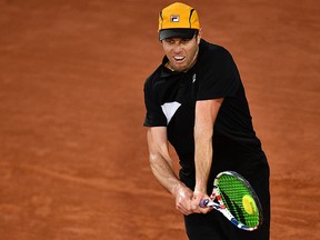 Sam Querrey returns the ball to Andrey Rublev during their first-round match at the French Open in Paris on September 29, 2020.