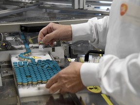An employee works on a production line at the factory of British multinational pharmaceutical company GlaxoSmithKline (GSK) in Saint-Amand-les-Eaux, France, on December 3, 2020.