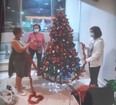 Residents of 855 Roselawn Ave. trim a Christmas tree in the lobby of their building, where a tree has been erected every holiday season for 25 years. But Toronto Community Housing Corporation has ordered the tree to be removed because of fire code violations and concerns over COVID-19 restrictions.