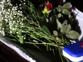 A Naloxine kit and roses inside a coffin left outside the home of Hamilton's mayor by Defund Hamilton Police Service protesters on Monday, Nov. 30, 2020.