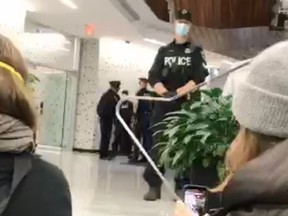 An image from video of Defund Hamilton Police Service protesters inside Hamilton City Hall with police on Wednesday, Dec. 2, 2020.