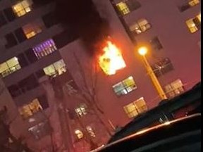 Flames can be seen at a Toronto Community Housing senior's building near Bathurst St. and Steeles Ave. Thursday, Dec. 10, 2020.