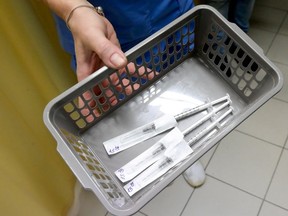 A healthcare worker carries a tray of prepared doses of Pfizer-BioNTech COVID-19 vaccine at the Del-Pest Central Hospital as the coronavirus disease (COVID-19) outbreak continues, in Budapest, Hungary, December 26, 2020.