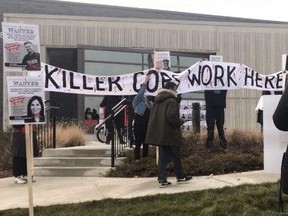 Anti-police protesters demonstrated outside Peel Regional Police Service's 11 Division in Mississauga on Friday, Dec. 11, 2020. The police station was also splattered with red paint.