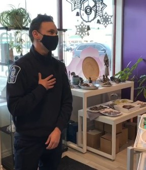 A bylaw officer issues a ticket to The Point of Light, Body, Mind, Spirit Store & Centre in Newmarket for opening during York Region lockdown on Wednesday, Dec. 23, 2020.