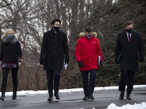 (Left to right) Minister of Infrastructure and Communities Catherine McKenna, Prime Minister Justin Trudeau, Minister of Canadian Heritage Steven Guilbeault and Minister of Environment and Climate Change Jonathan Wilkinson walk to make an announcement on the government's updated climate change plan in the Dominion Arboretum in Ottawa, on Friday, Dec. 11, 2020.