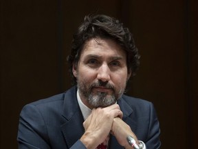 Prime Minister Justin Trudeau listens to a question during a year end interview.