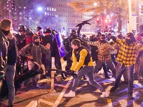 Members of the far-right group Proud Boys clash with counter protesters, in downtown Washington, U.S., December 12, 2020.
