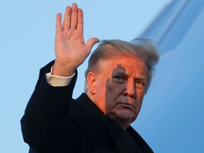 U.S. President Donald Trump waves as he boards Air Force One at Joint Base Andrews in Maryland, U.S., December 23, 2020.
