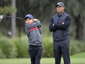 Tiger Woods watches as his son Charlie tees off on the 12th hole during a practice round for the PNC Championship in Orlando, Fla., on Thursday.