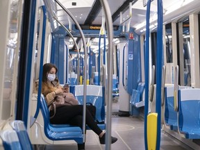 A commuter rides a near-empty subway train in Montreal, on Monday, May 25, 2020.