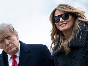 U.S. President Donald Trump and First Lady Melania Trump walk from Marine One as they return to the White House on December 31, 2020, in Washington, DC.