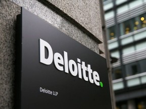 A Deloitte logo is pictured on a sign outside the company's offices in London on September 25, 2017.