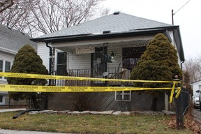 A yellow police tape is shown around a house on Essex Street in Sarnia on Sunday. Sarnia police are investigating the death of 66-year-old Sue Elin Lumsden, who lived there alone.