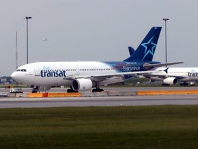 Air Transat jets prepare to take off at at Montréal-Trudeau International Airport in June 2018.