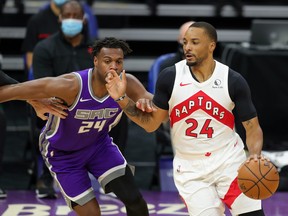 Toronto Raptors guard Norman Powell dribbles the ball against Sacramento Kings guard Buddy Hield on Friday night.