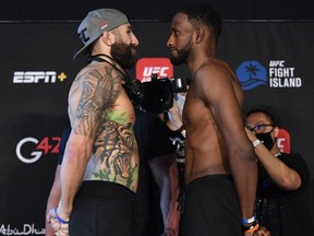 In this handout image provided by the UFC, opponents Michael Chiesa (L) and Neil Magny face off during the UFC weigh-in at Etihad Arena on UFC Fight Island on January 19, 2021 in Abu Dhabi, United Arab Emirates.