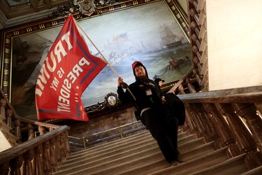 A protester holds a Trump flag inside the US Capitol Building near the Senate Chamber on January 06, 2021 in Washington, DC. 
 (Photo by Win McNamee/Getty Images)