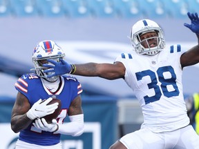 Stefon Diggs #14 of the Buffalo Bills catches a touchdown pass as T.J. Carrie #38 of the Indianapolis Colts defends during the second half of the AFC wild-card playoff game at Bills Stadium on January 09, 2021 in Orchard Park, New York.
