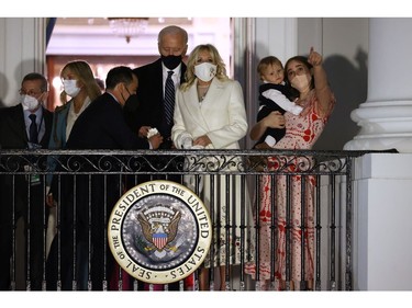 U.S. President Joe Biden, first lady Jill Biden and members of their family watch a fireworks show on the National Mall from the Truman Balcony at the White House Jan. 20, 2021 in Washington, D.C.