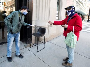 Guy Legault picks up cannabis at the curbside in front of Meta Cannabis store in Toronto on April 8, 2020.