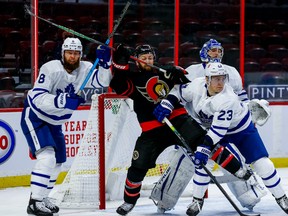 Ottawa Senators centre Derek Stepan  battles with Toronto Maple Leafs defenceman Jake Muzzin (left) and defenseman Travis Dermott in front of goaltender Frederik Andersen on Friday night.