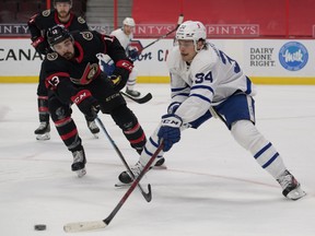 Toronto Maple Leafs centre Auston Matthews evades Ottawa Senators left winger Nick Paul during Saturday's game.
