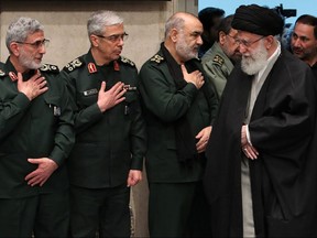 In this file handout picture provided by the office of Iran's Supreme Leader Ayatollah Ali Khamenei on January 9, 2020 shows Khamenei (R) greeting newly-appointed commander of the Quds Force of the Islamic Revolutionary Guard Corps Esmail Qaani (L), Iranian Armed Forces Chief of Staff Major General Mohammad Bagheri (C), and Iranian Islamic Revolutionary Guard Corps (IRGC) Chief Commander Hossein Salami, during a mourning ceremony in Tehran for slain top general Qasem Soleimani.